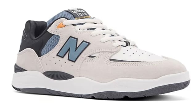 Grey and blue New Balance shoes.